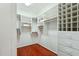 Walk-in closet with wood floors and many storage shelves, offering ample space at 5310 W Melinda Ln, Glendale, AZ 85308