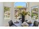 Dining area with decorative centerpiece and views of the desert landscape at 5310 W Melinda Ln, Glendale, AZ 85308