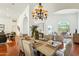 Bright dining room with chandelier, hardwood floors, and comfortable seating at 5310 W Melinda Ln, Glendale, AZ 85308