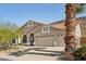 Inviting single-story home with desert landscaping, a three-car garage, and a tile roof at 5310 W Melinda Ln, Glendale, AZ 85308