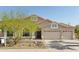 Charming single-story home featuring a three-car garage, desert landscaping, and a tile roof at 5310 W Melinda Ln, Glendale, AZ 85308
