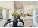 Dining area with black table and views of the bright kitchen and living spaces at 5310 W Melinda Ln, Glendale, AZ 85308