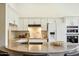 Bright kitchen features white cabinetry, granite counters, tiled backsplash, and stainless steel appliances at 5310 W Melinda Ln, Glendale, AZ 85308