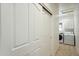 Hallway with sliding closet doors leading to laundry room with washer and dryer at 5310 W Melinda Ln, Glendale, AZ 85308