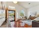 Bright living room with high ceilings, arched window, hardwood floors and decorative front door at 5310 W Melinda Ln, Glendale, AZ 85308