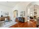 Elegant living room with arched doorways, hardwood floors, and comfortable seating at 5310 W Melinda Ln, Glendale, AZ 85308