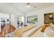 Sunlit main bedroom featuring hardwood floors, patio access, and views of the backyard at 5310 W Melinda Ln, Glendale, AZ 85308