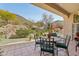 Covered patio with seating area and landscaped view of the backyard at 5310 W Melinda Ln, Glendale, AZ 85308