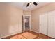 Bedroom with wood floors, a ceiling fan, and view of another bedroom at 6129 S White Pl, Chandler, AZ 85249