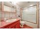 Functional bathroom with a shower, vanity, mirror, and red tile at 6331 W Eva St, Glendale, AZ 85302