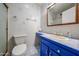 Bathroom features a toilet, sink with blue vanity, and a mirror cabinet at 6331 W Eva St, Glendale, AZ 85302