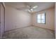 Bedroom featuring carpet flooring, a ceiling fan, and a window for natural light at 6331 W Eva St, Glendale, AZ 85302