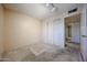 Clean bedroom with carpet, closet, and view of an open doorway to another room at 6331 W Eva St, Glendale, AZ 85302