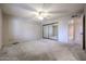 Bedroom with carpeted floor, closet with mirror doors, and view into the bathroom at 6331 W Eva St, Glendale, AZ 85302