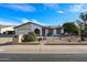 Inviting single-Gathering home with a well-manicured front yard and charming desert landscaping at 6331 W Eva St, Glendale, AZ 85302