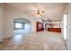 Expansive living space with tile flooring seamlessly connecting the living, dining, and kitchen areas at 6331 W Eva St, Glendale, AZ 85302
