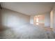 Spacious living room with open archway, neutral paint, and carpeted flooring for a cozy feel at 6331 W Eva St, Glendale, AZ 85302
