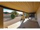 Covered patio showcasing a serene backyard setting, landscaping and a well-maintained gravel area at 6331 W Eva St, Glendale, AZ 85302