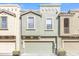 Exterior shot of townhomes with private garages and desert landscaping at 6710 E University Dr # 167, Mesa, AZ 85205