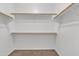 Spacious walk-in closet equipped with built-in shelving and hanging rods at 6710 E University Dr # 167, Mesa, AZ 85205