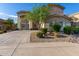 Two-story home featuring a large driveway, neutral stucco, and desert landscaping at 6838 W Lynne Ln, Laveen, AZ 85339