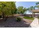 Landscaped backyard with gravel, artificial turf, and covered patio, perfect for outdoor living at 6993 S Ruby Dr, Chandler, AZ 85249