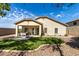 Spacious backyard showcasing an artificial lawn, gravel, and a covered patio area at 6993 S Ruby Dr, Chandler, AZ 85249