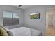 Well-lit bedroom features a TV, window with blinds, and neutral color scheme at 6993 S Ruby Dr, Chandler, AZ 85249