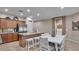 Spacious kitchen that opens to a dining area, with stainless steel appliances and a kitchen island at 6993 S Ruby Dr, Chandler, AZ 85249