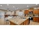 Open concept kitchen with an island, pendant lighting, and a seamless view into the living area at 6993 S Ruby Dr, Chandler, AZ 85249