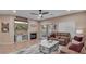 Inviting living room with a ceiling fan, fireplace, and cozy sofa, perfect for relaxing and entertaining guests at 6993 S Ruby Dr, Chandler, AZ 85249