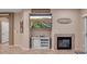 Living room with a fireplace, and a wall-mounted TV, perfect for relaxing and entertaining guests at 6993 S Ruby Dr, Chandler, AZ 85249