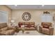 Inviting living area with cozy seating, a decorative clock, and natural light flowing in from large windows at 6993 S Ruby Dr, Chandler, AZ 85249