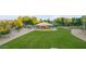 Aerial view of neighborhood playground with green grass, trees, and shade structures at 6993 S Ruby Dr, Chandler, AZ 85249