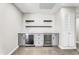 Stylish bar area with beverage coolers, white cabinetry, and modern shelving at 7745 N 33Rd Ave, Phoenix, AZ 85051