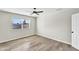 Bright bedroom with modern ceiling fan, light hardwood floors and a sunlit window at 7745 N 33Rd Ave, Phoenix, AZ 85051