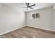 Bedroom with hardwood floors, ceiling fan, and large window at 7745 N 33Rd Ave, Phoenix, AZ 85051