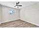 Cozy bedroom with hardwood floors, ceiling fan, and sunny window at 7745 N 33Rd Ave, Phoenix, AZ 85051