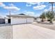 View of home featuring a white exterior, an attached garage, and a concrete driveway at 7745 N 33Rd Ave, Phoenix, AZ 85051
