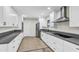 Modern kitchen features stainless steel appliances, white cabinetry, and tile flooring at 7745 N 33Rd Ave, Phoenix, AZ 85051