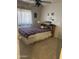 Comfortable bedroom with carpet flooring, a full-size bed, ceiling fan, and a window with curtains at 8863 W Greer Ave, Peoria, AZ 85345