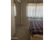 Bedroom featuring carpeted floors, mirrored closet doors, and a window providing natural light at 8863 W Greer Ave, Peoria, AZ 85345