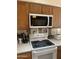 Kitchen with a white range, hood, and microwave at 8863 W Greer Ave, Peoria, AZ 85345