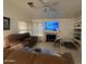 Bright living room with tile flooring, ceiling fan, and a cozy fireplace at 8863 W Greer Ave, Peoria, AZ 85345