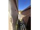 Narrow side yard with gravel and a modern air conditioning unit at 8863 W Greer Ave, Peoria, AZ 85345