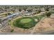 Overhead shot of a well-manicured golf course with a green, sand traps, and surrounding homes at 915 S Saranac Ave, Mesa, AZ 85208