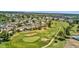 An aerial view of a lush golf course with manicured green fairways and community homes at 915 S Saranac Ave, Mesa, AZ 85208