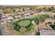 Aerial view of a golf course with mature landscaping adjacent to a neighborhood of single-Gathering homes at 915 S Saranac Ave, Mesa, AZ 85208