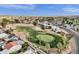 Aerial view showcases a golf course set amongst residential homes in a well-maintained community at 915 S Saranac Ave, Mesa, AZ 85208
