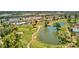 Scenic overhead view of a golf course with a water feature surrounded by homes and lush greenery at 915 S Saranac Ave, Mesa, AZ 85208